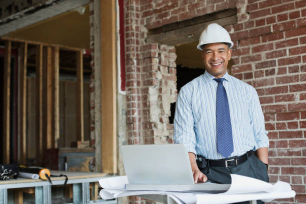 A project manager smiling as the construction project he has been working on undergoes renovations.