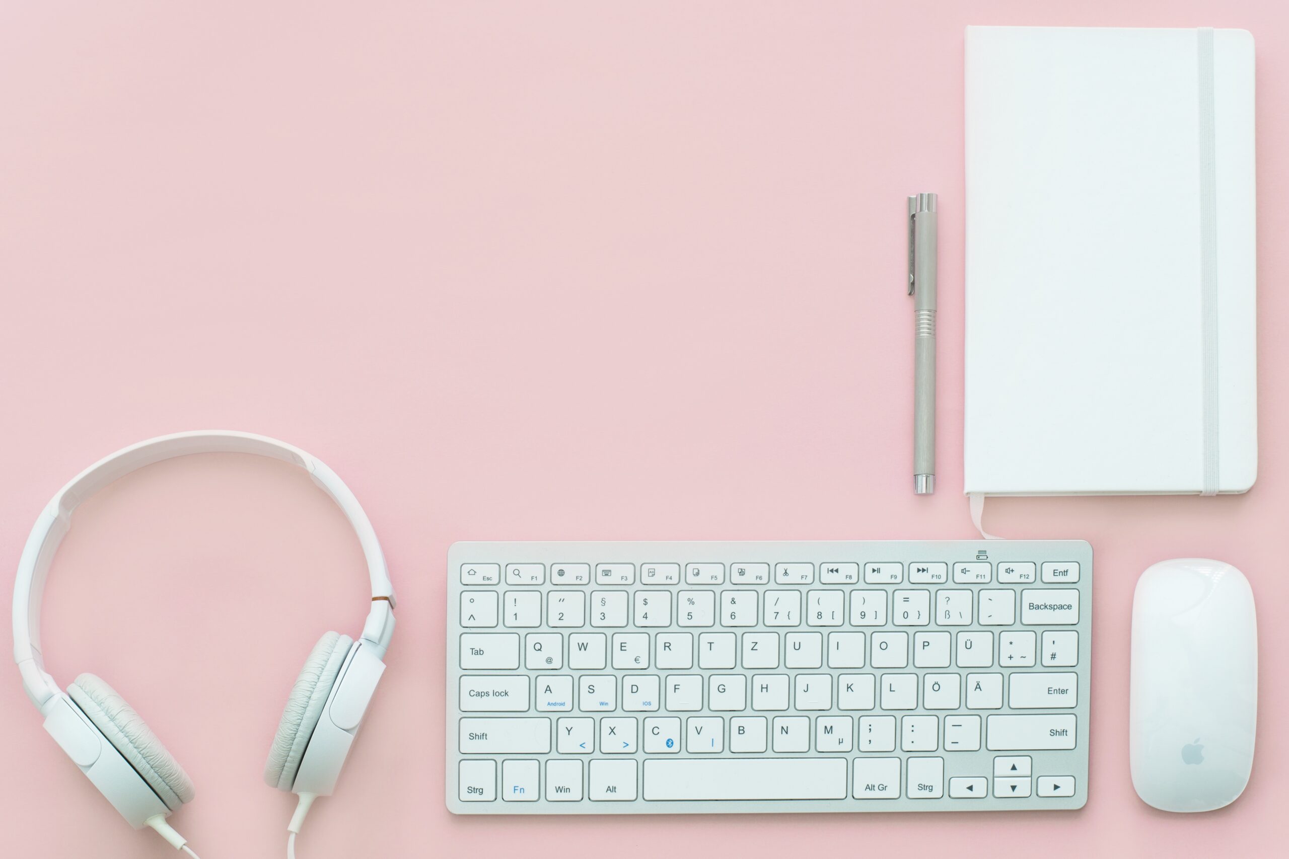 A workspace with the headphones, keyboard, and mouse connected to a computer that is on a Microsoft Teams call in which a project manager is discussing the role of predecessors in project management endeavors.